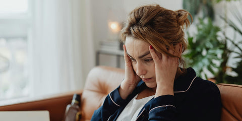 A Caucasian woman feeling tired and other symptoms of brain fog